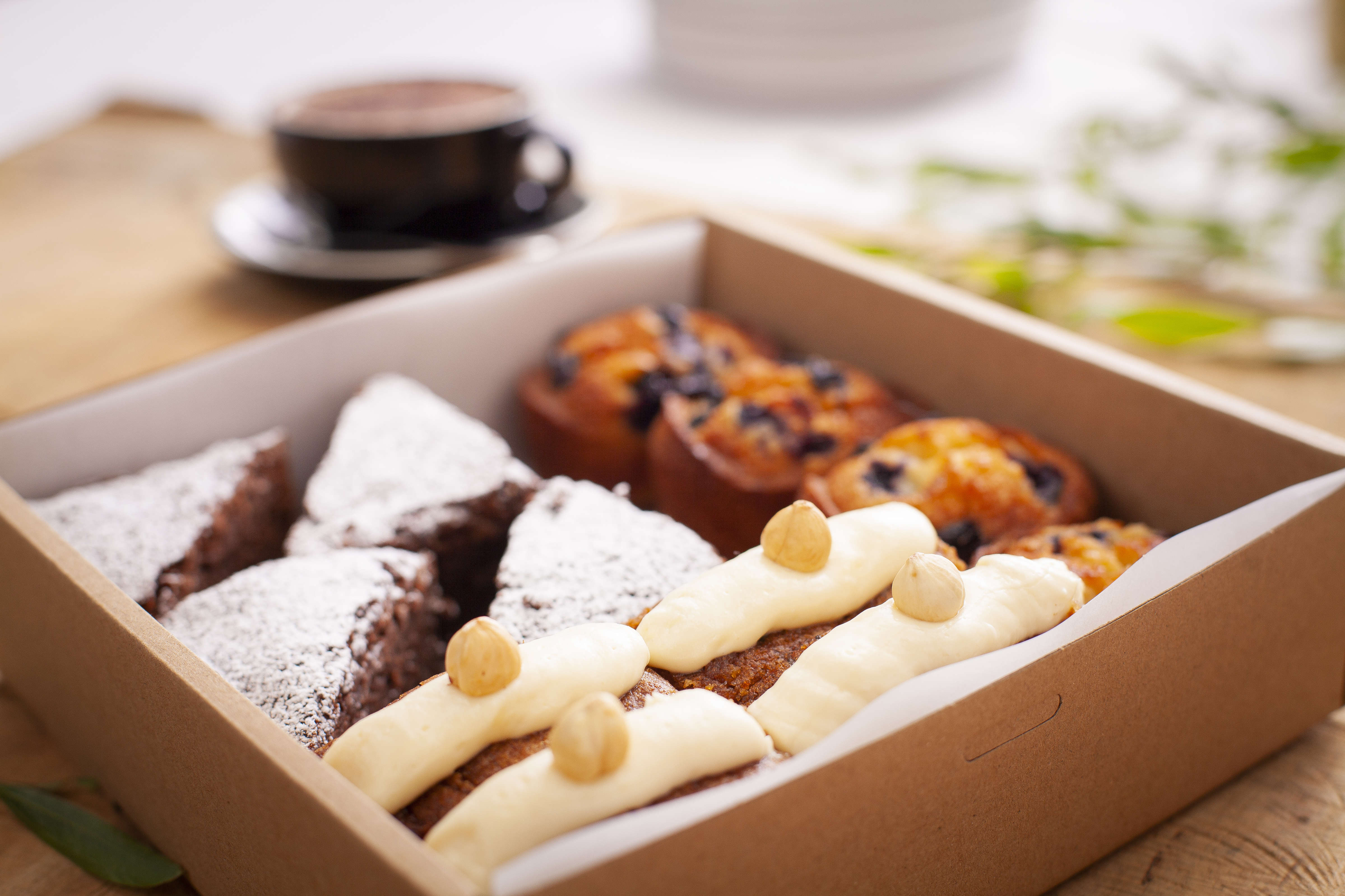 Cappuccino with gluten free sweet box containing 12 items including chocolate brownie, friands, cake. Photo: Richard Jupe.