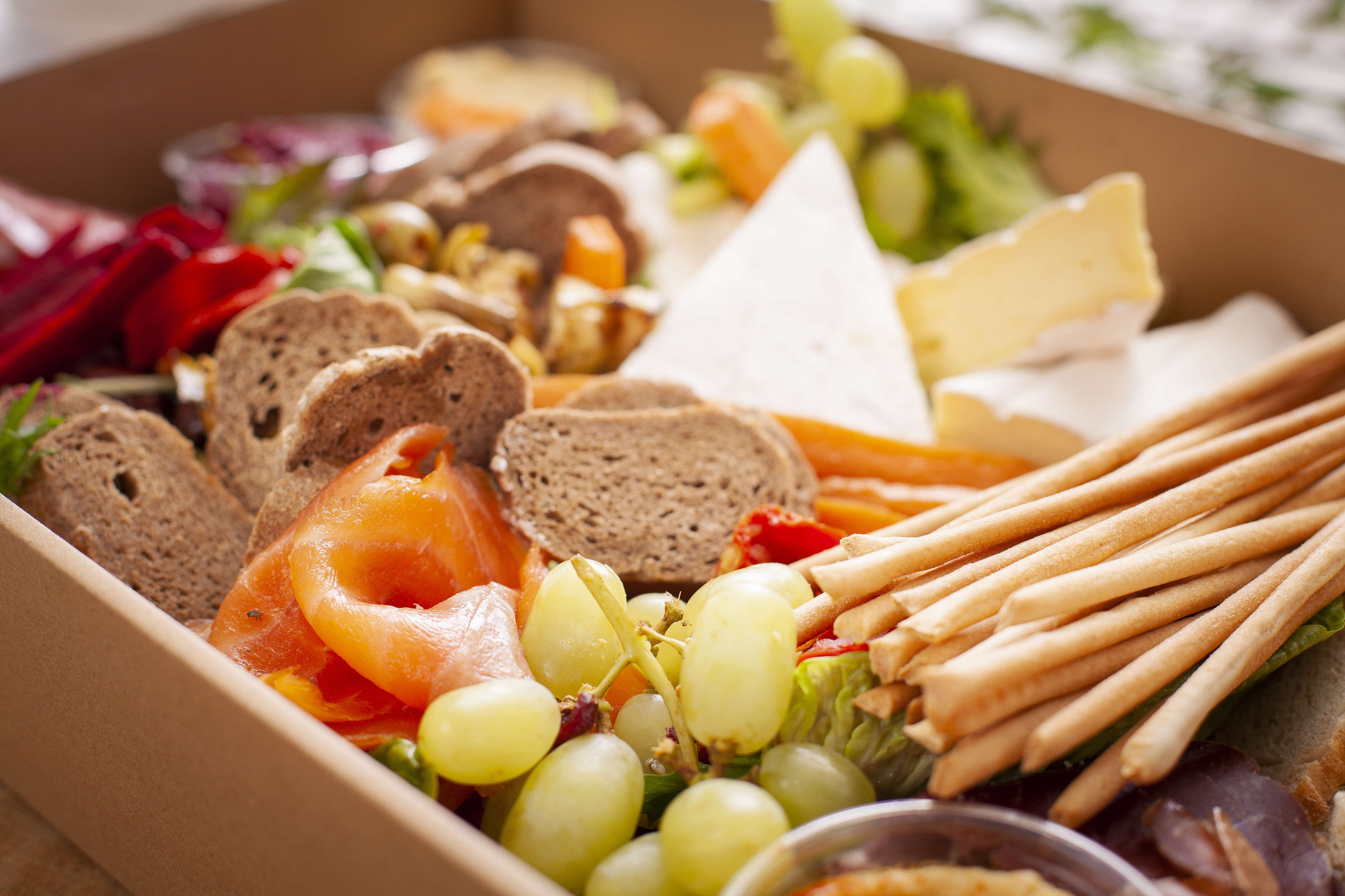 Close up of antipasto box, including Casalingo salami, bresaola, smoked salmon, marinated olives, artichokes, carrots, hummus, Tasmanian Brie, grissini, sliced baguette. Photo: Richard Jupe.