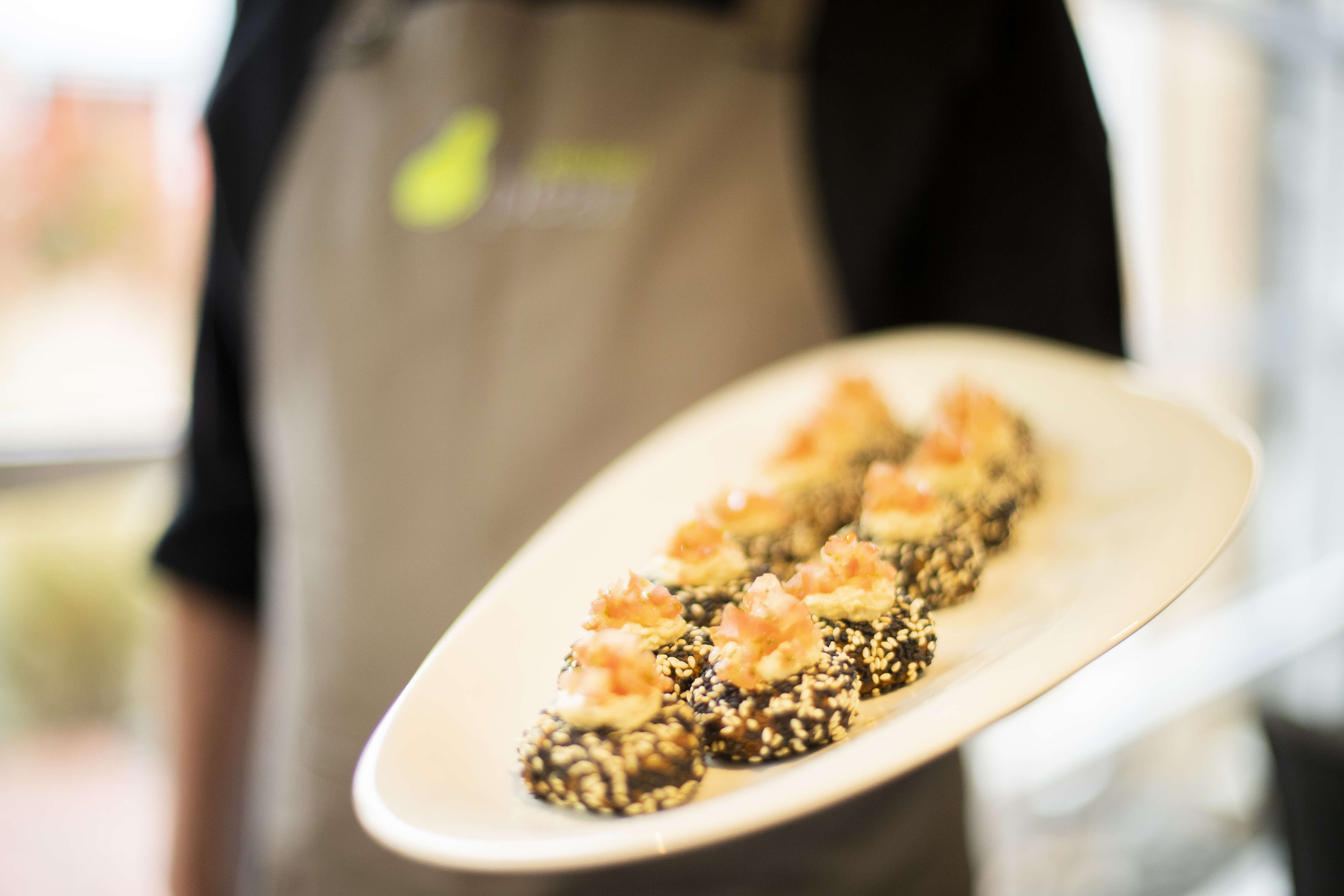 Staff serving a platter of felafel with hummus and salsa. Photo: Richard Jupe.